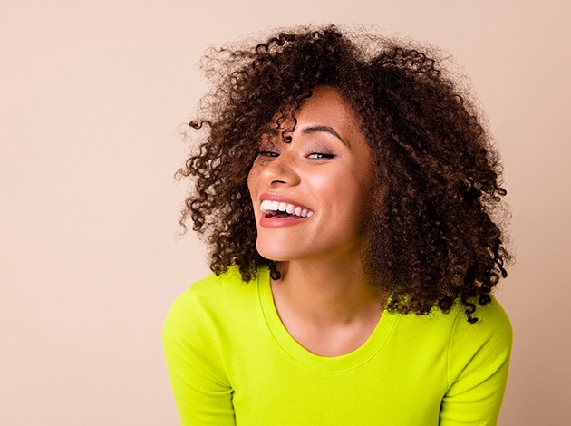 Woman smiling after receiving veneers