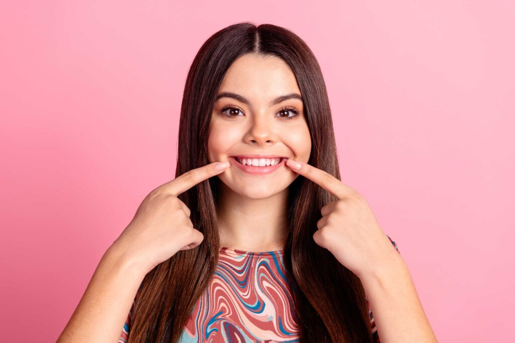 Woman pointing to her teeth